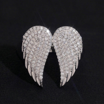 S925 sterling silver full iced out moissanite angel wings ring on dark background