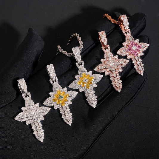 Hand in black glove holding S925 silver moissanite floral cluster cross pendants in pink yellow and clear stones