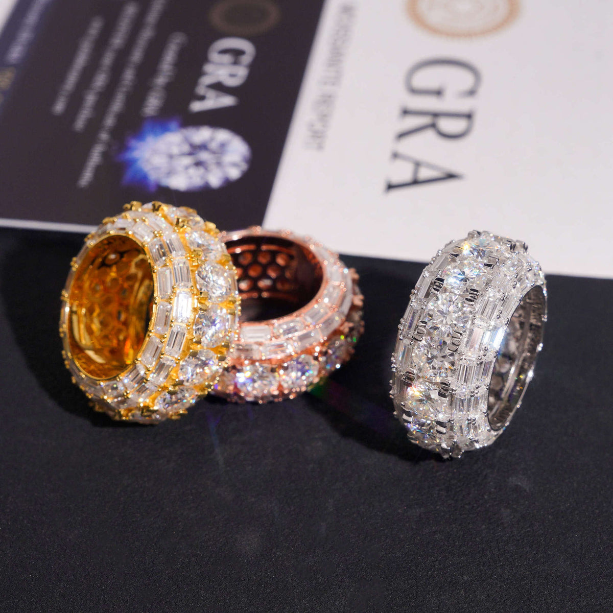 Three-color S925 silver moissanite round and baguette 3-row band rings displayed with GRA certificate card   