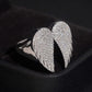 Side angle view of S925 silver iced out moissanite angel wings ring on display stand