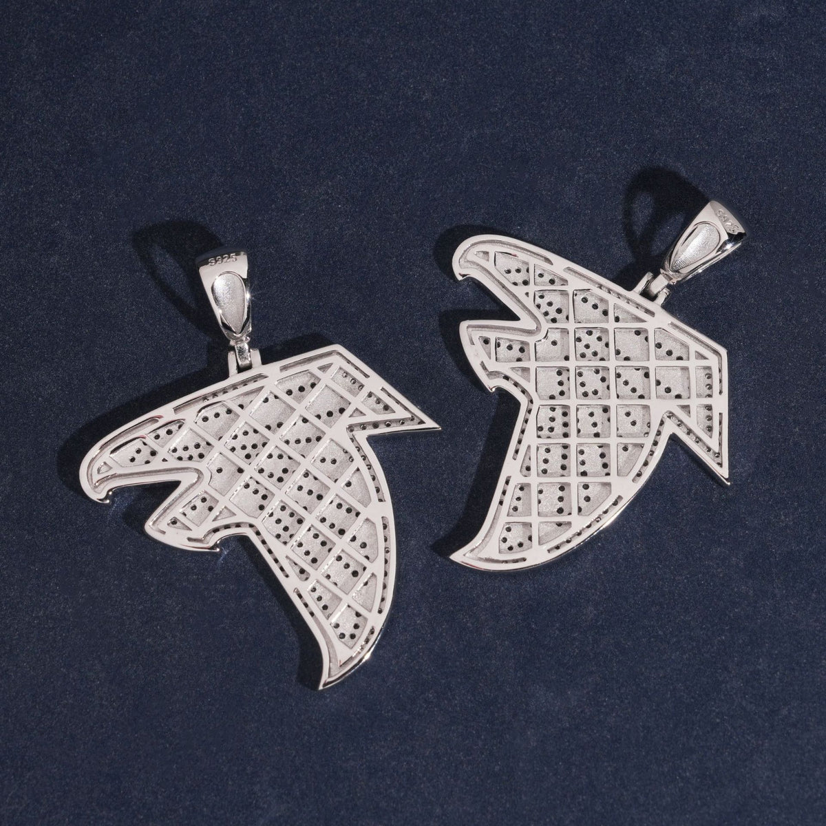 Hollow mesh back view of S925 sterling silver iced out moissanite falcon bird logo pendants on dark background   