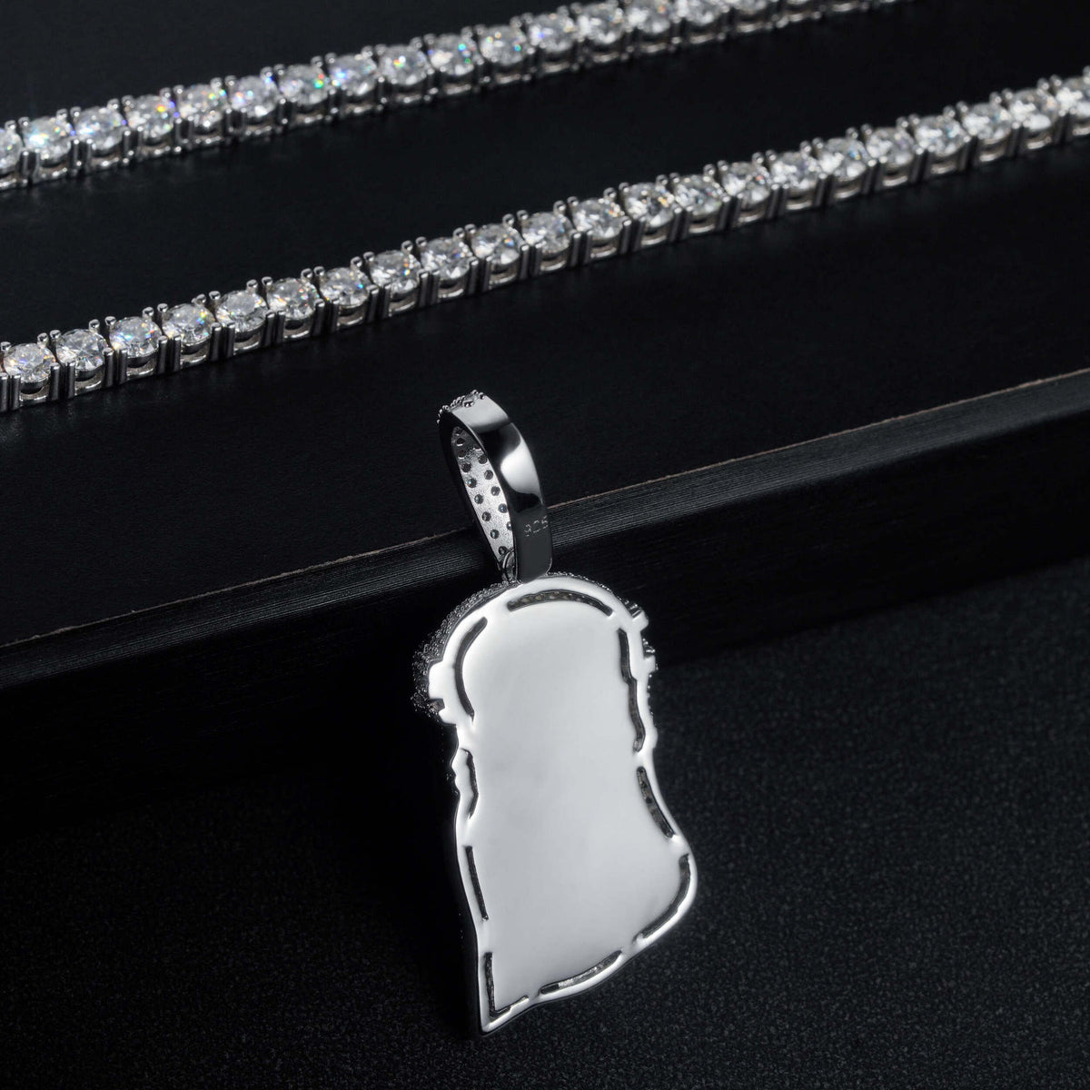Smooth polished back view of S925 sterling silver iced out moissanite classic Jesus piece pendant on display box   