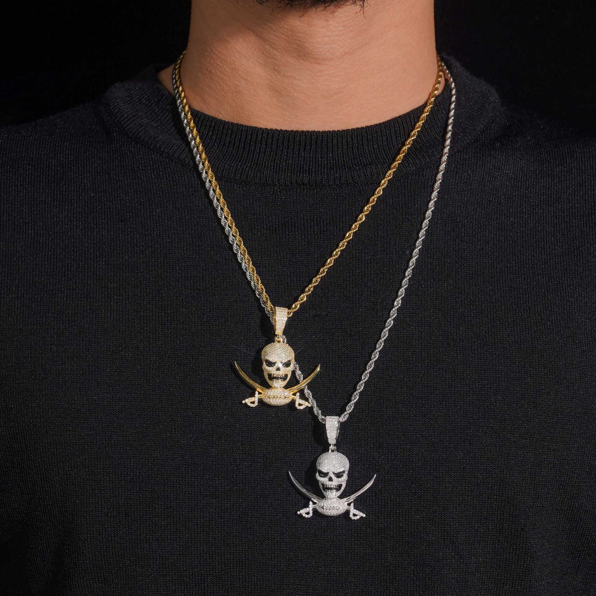 Model wearing layered S925 sterling silver iced out moissanite pirate skull and swords pendant necklaces