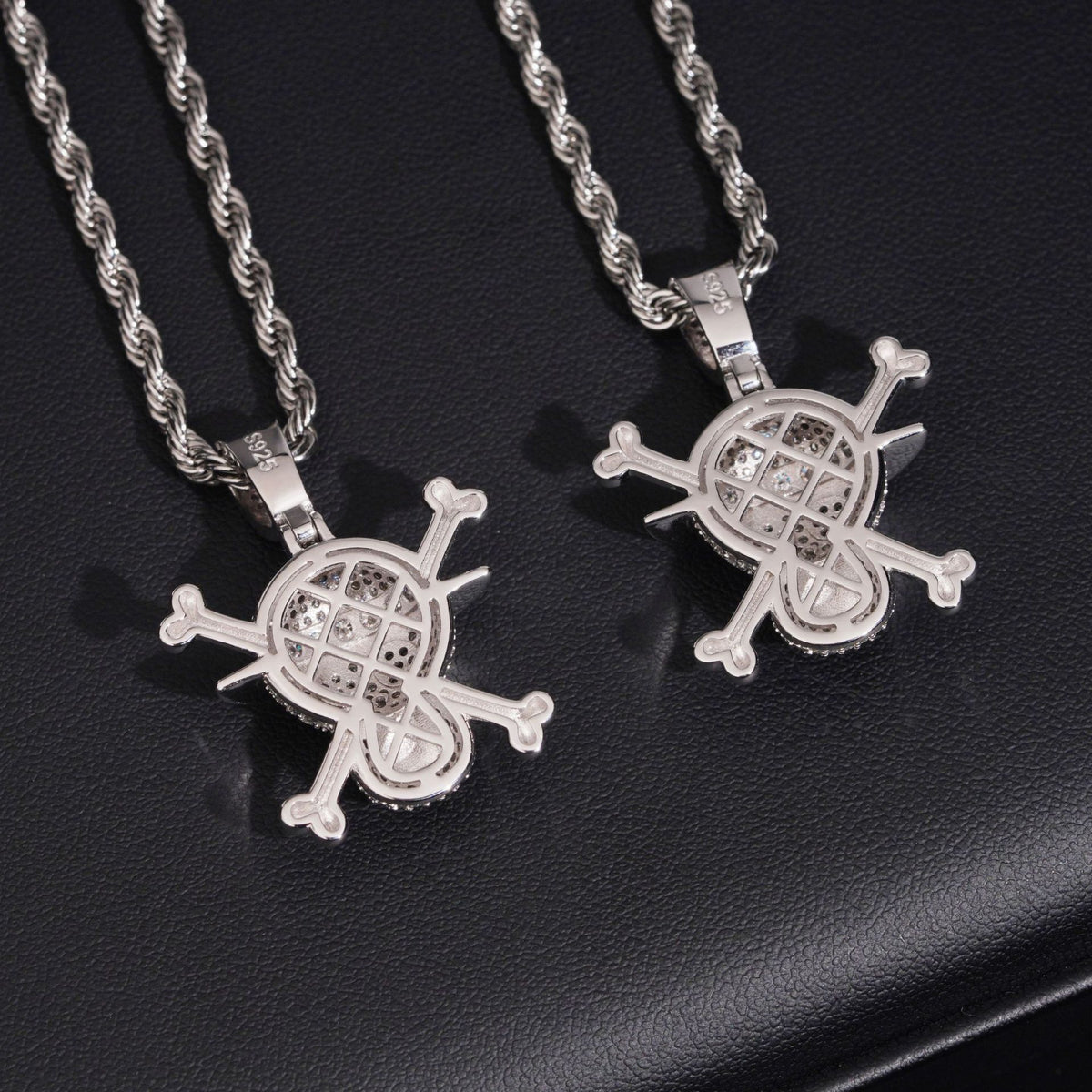 Hollow mesh back view of S925 sterling silver iced out moissanite straw hat pirate skull pendants on dark display
