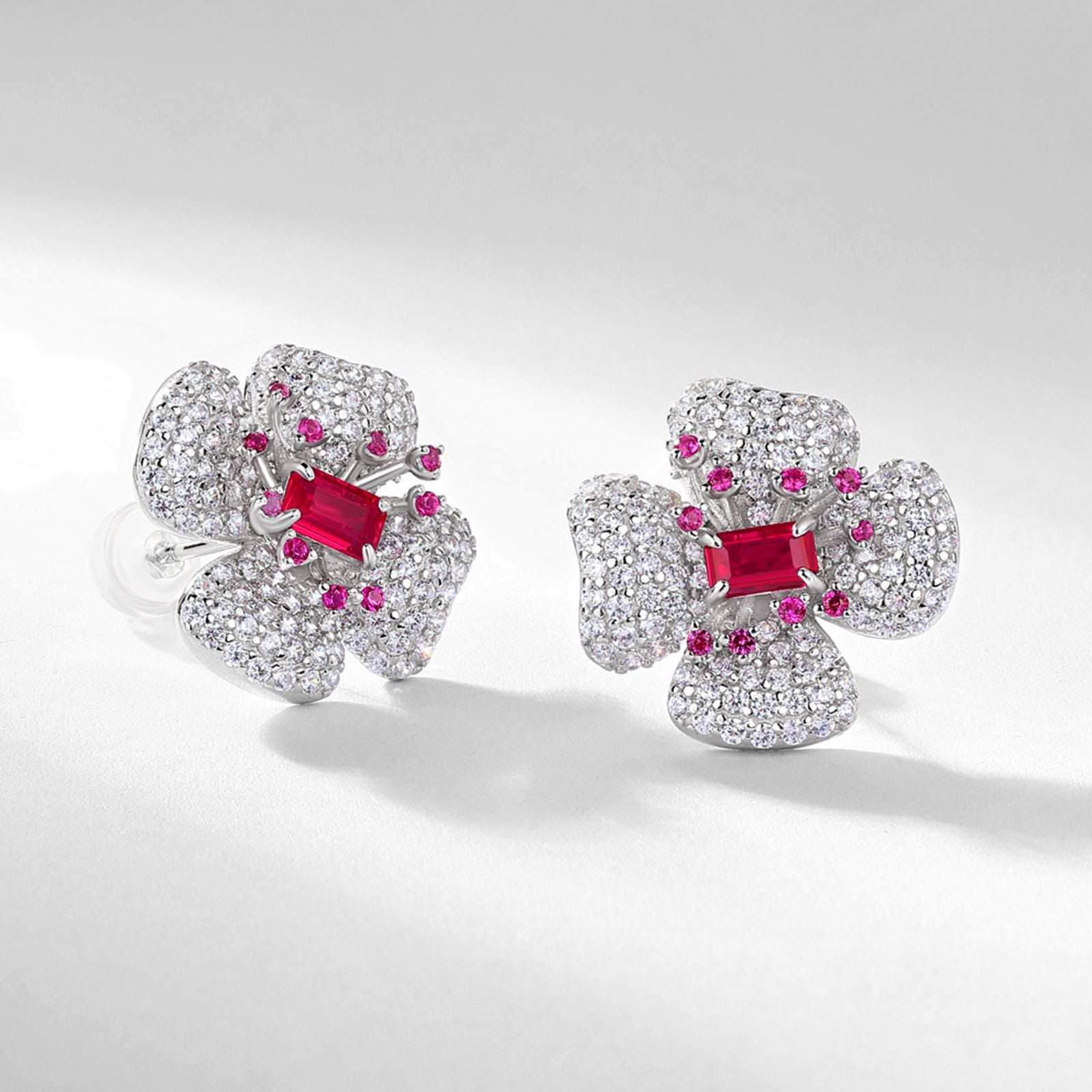 Close-up of secure butterfly push-back closure on ruby stud earrings.