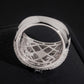 Inside band view showing lattice hollow pattern of seven stone flower cluster moissanite wide ring