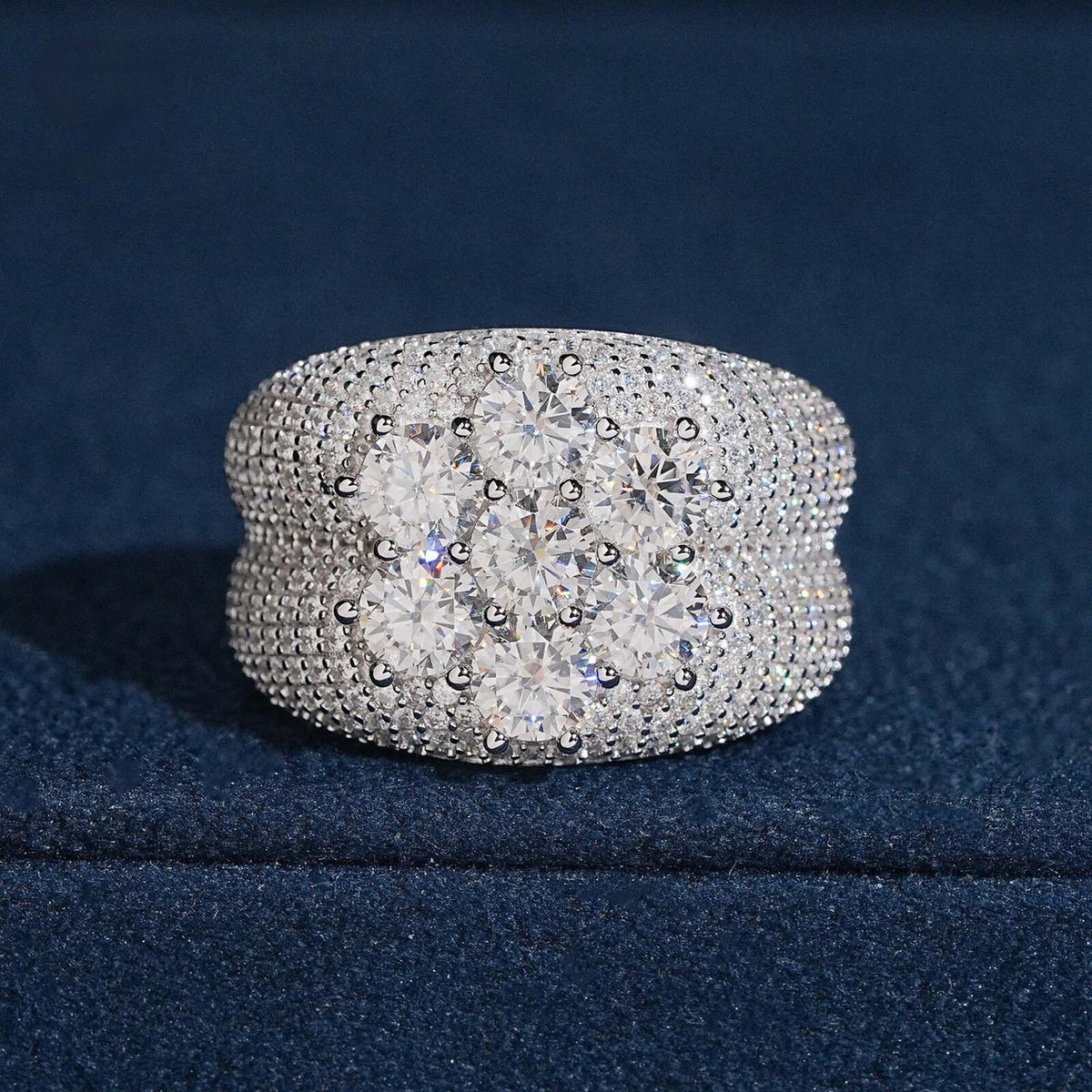 Seven stone flower cluster moissanite wide band ring with pave stones on dark blue display box