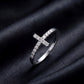 Side profile view of sideways cross lab grown diamond ring standing on black silk   