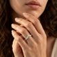 Model wearing silver graduated round moissanite chevron stacking ring in a daylight studio shot.