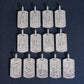 White gold S925 silver iced out moissanite baguette initial dog tag pendants arranged in ordered grid