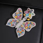 White gold S925 sterling silver iced out multi-color moissanite butterfly pendant on dark surface