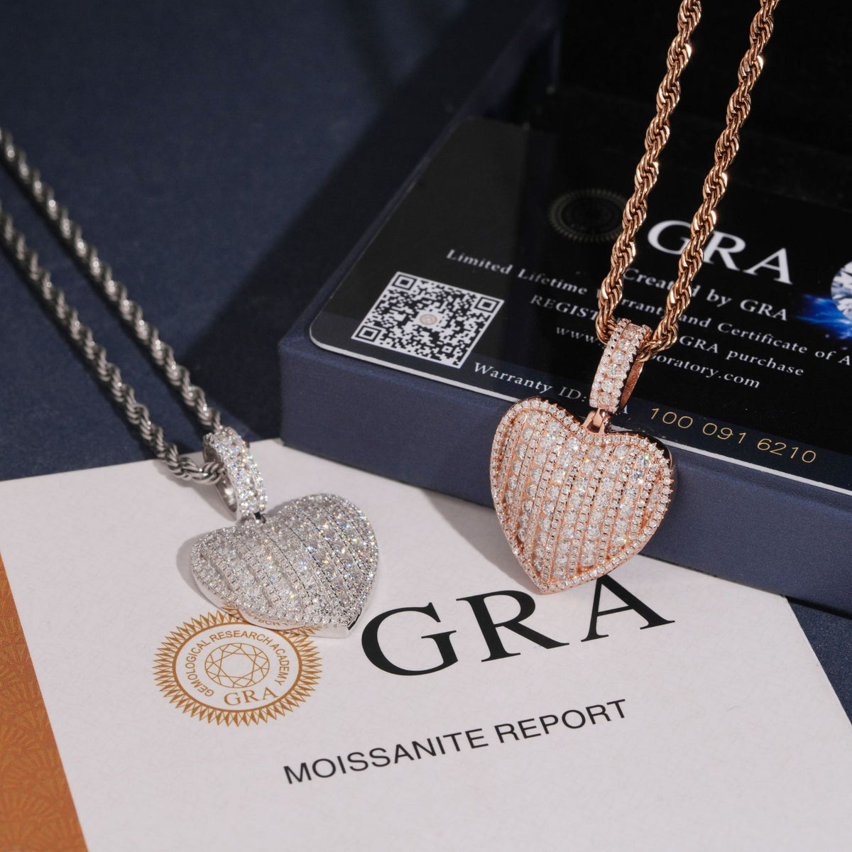Silver and rose gold S925 iced out moissanite 3D heart pendants presented on GRA certificate booklets