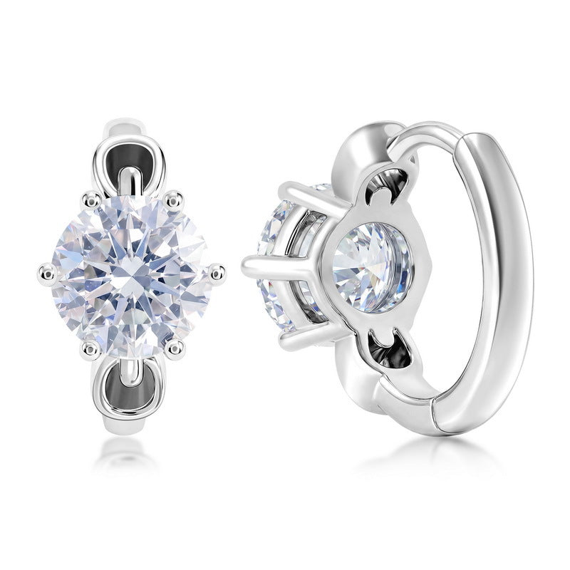 Six-prong round diamond solitaire huggie hoop earrings in platinum-plated sterling silver.