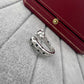 Cartier Panthère de ring by Zerra Jewelry featuring narrow design, garnet stones, and lacquer accents.
