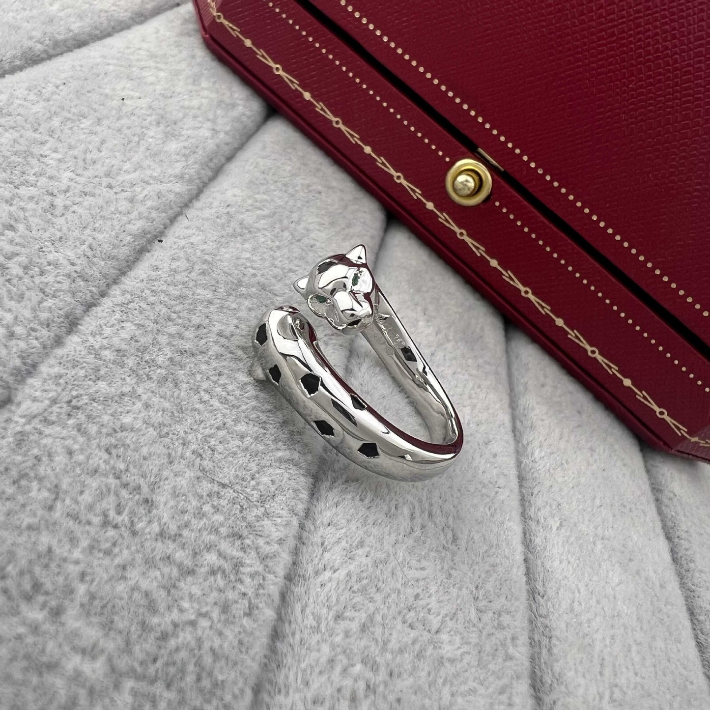 Cartier Panthère de ring by Zerra Jewelry featuring narrow design, garnet stones, and lacquer accents.
