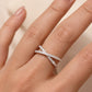 Woman wearing sparkling lab grown diamond criss cross x-ring on index finger