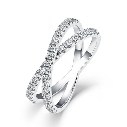 Sparkling lab grown diamond criss cross x-ring in sterling silver isolated on white background