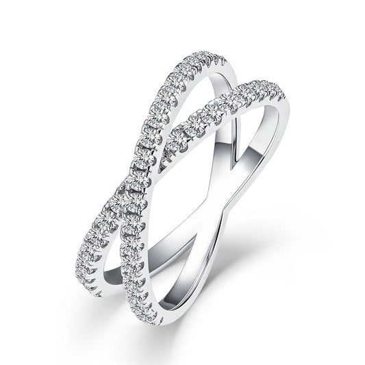 Sparkling lab grown diamond criss cross x-ring in sterling silver isolated on white background