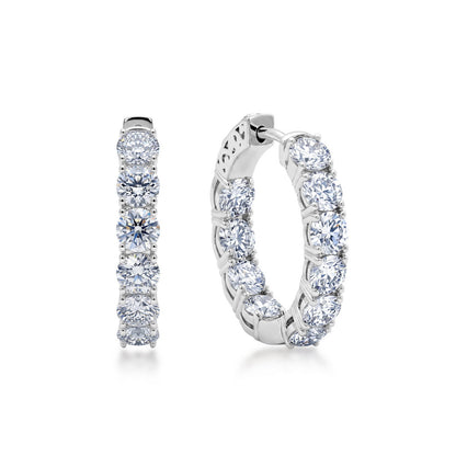 Sparkling lab grown diamond eternity hoop earrings in sterling silver isolated on white background