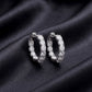 Sparkling lab grown diamond eternity hoop earrings set on dark black silk fabric
