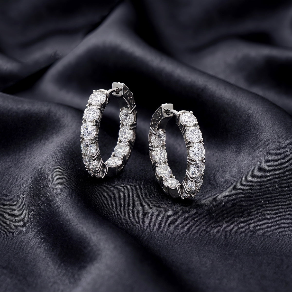 Side view profile of sparkling lab grown diamond eternity hoop earrings on black silk