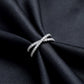 Side profile view of lab grown diamond x-ring standing on black silk