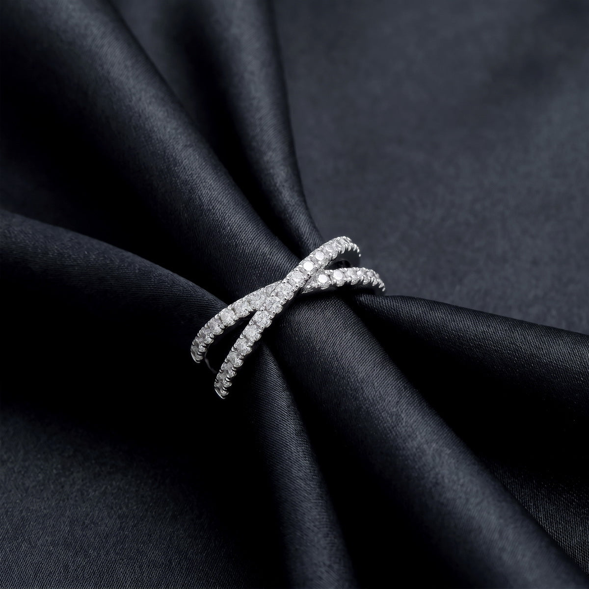 Side profile view of lab grown diamond x-ring standing on black silk