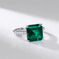 Ring with a large green gemstone on a light gray background