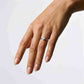 Full hand view of model wearing square emerald cut kite set engagement ring.