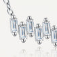Close-up showing staggered vertical baguette moissanites and prong settings on bar necklace.