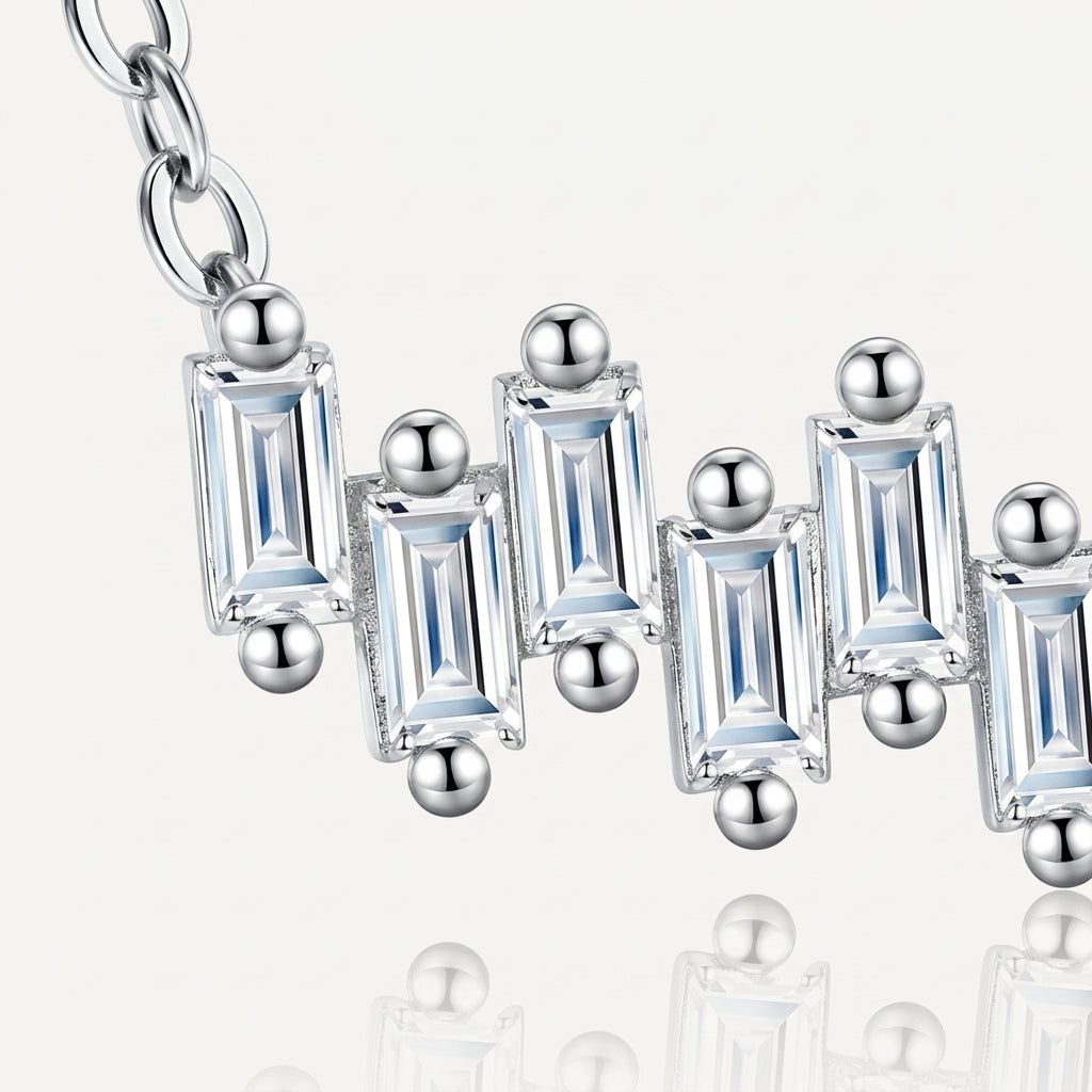 Close-up showing staggered vertical baguette moissanites and prong settings on bar necklace.