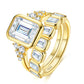 Studio perspective display of gold bezel set emerald cut moissanite engagement ring and matching eternity wedding band set.