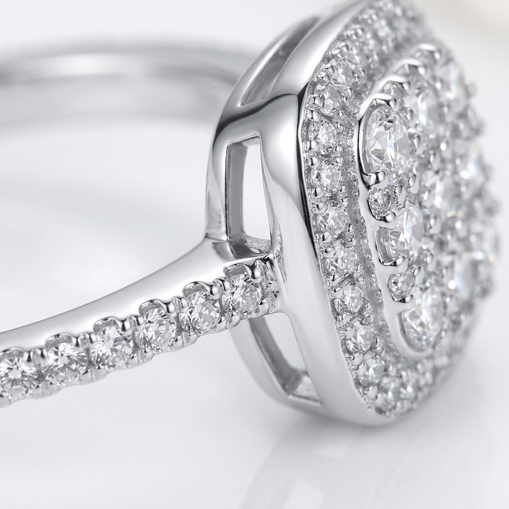 Studio macro close-up highlighting the raised cushion halo profile, stone basket setting, and pave-set moissanite band.