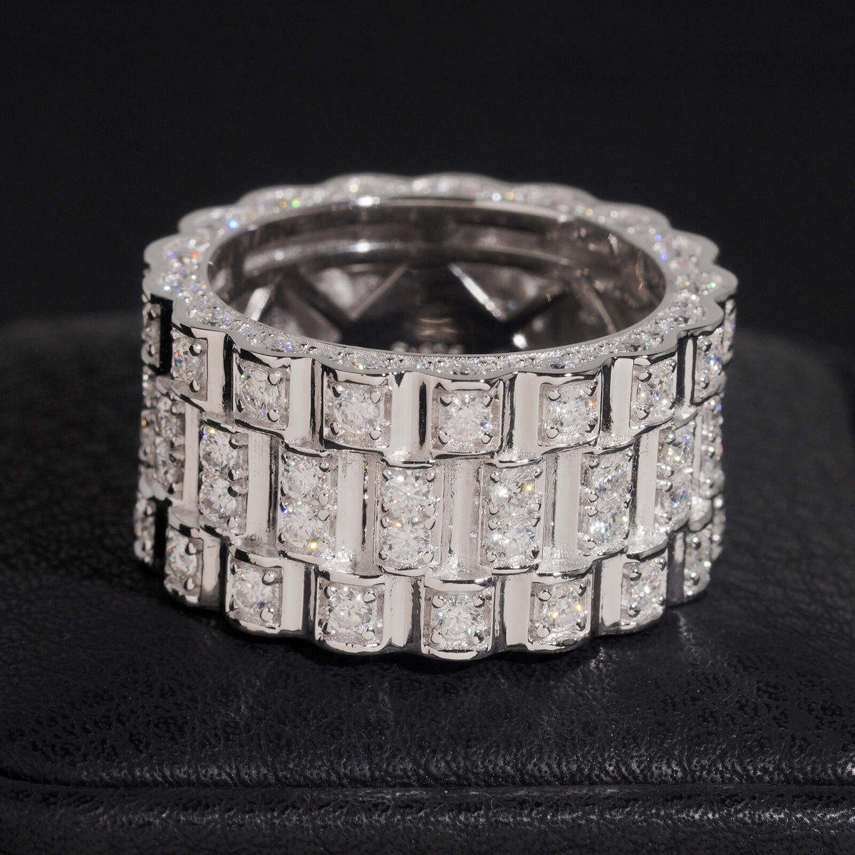Angled view showing inner hollow pattern of three row watch link moissanite wide ring