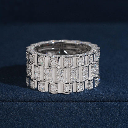 Three row watch link moissanite wide band ring in sterling silver on dark blue box