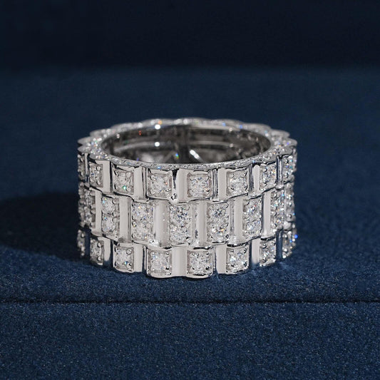 Three row watch link moissanite wide band ring in sterling silver on dark blue box