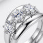 Close-up of round three-stone basket setting and flush curved plain guard band.