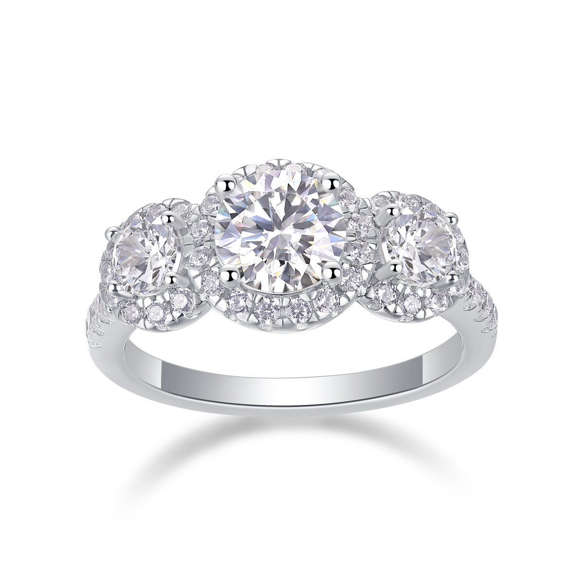 Three stone halo moissanite engagement ring with pave band on white background.