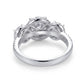 Macro view of side profile showing 3-halo basket setting and pave band on silver ring.