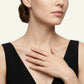 High-end editorial lookbook shot of a model wearing a timeless minimalist round gemstone eternity statement jewelry ring with a black dress.