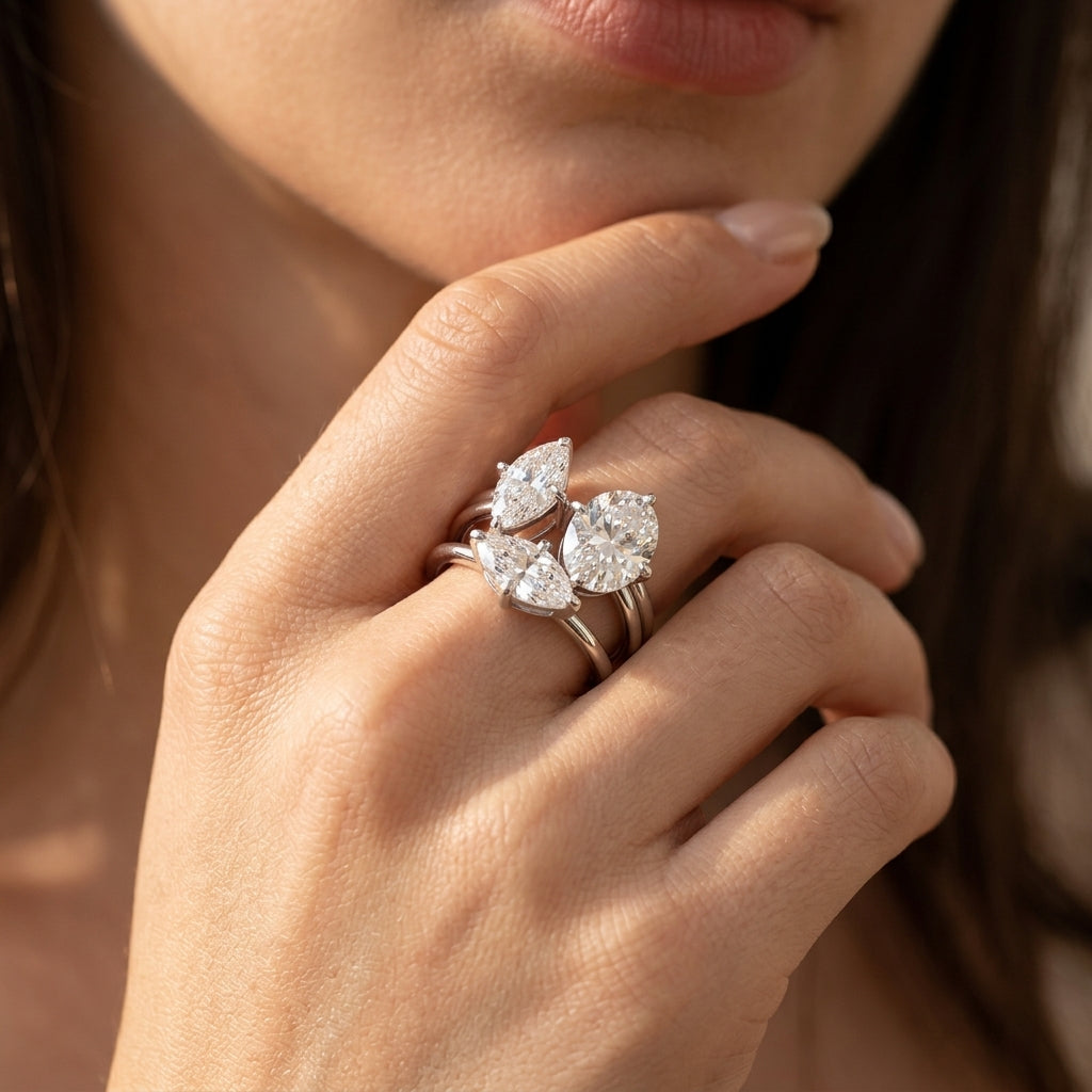 Model wearing two piece Toi et Moi oval and marquise moissanite stacking ring set.