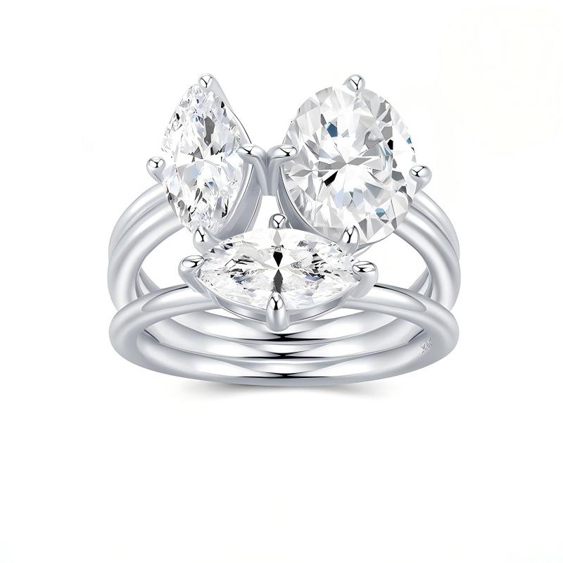 Toi et Moi moissanite ring set featuring oval and marquise stones on white background.