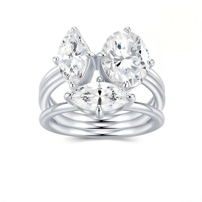 Toi et Moi moissanite ring set featuring oval and marquise stones on white background.