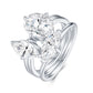 Angled view of interlocking Toi et Moi oval and marquise moissanite ring set.