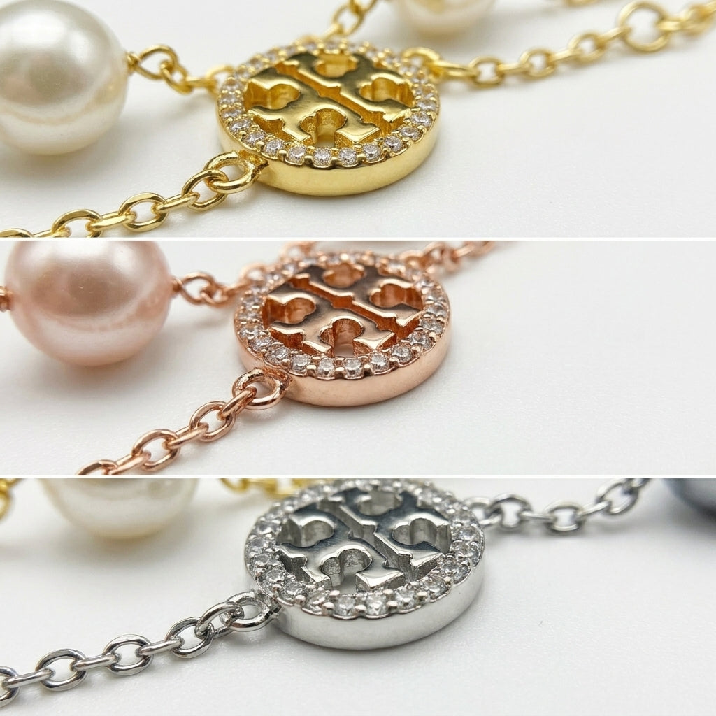 Detailed shot of the secure lobster clasp and the signature Double T logo charm on the pearl bracelet