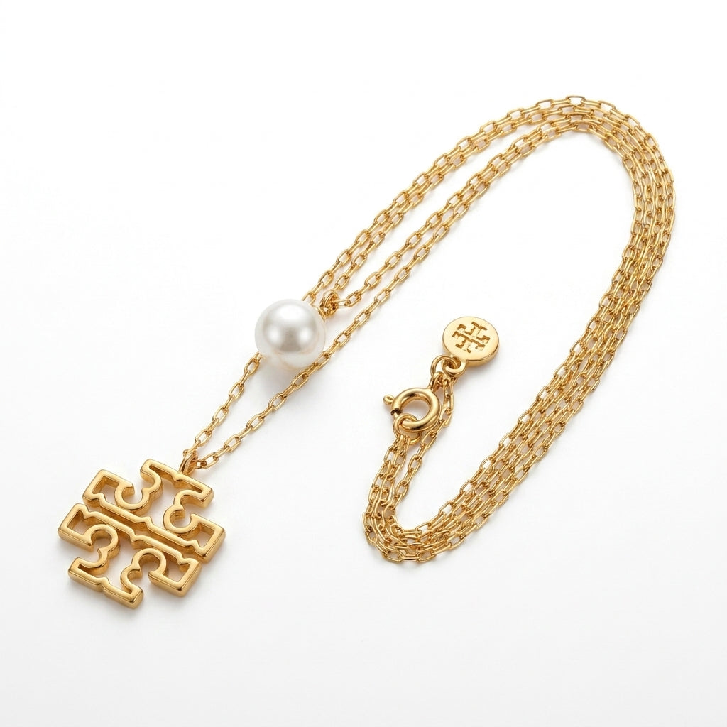 Tory Burch Britten Double Strand Necklace in 18k gold-plated finish with layered chains and logo
