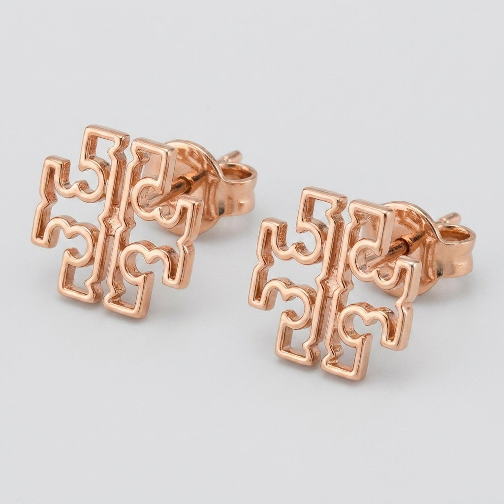 Macro detail of the high-shine gold finish and secure butterfly post back on Britten logo studs