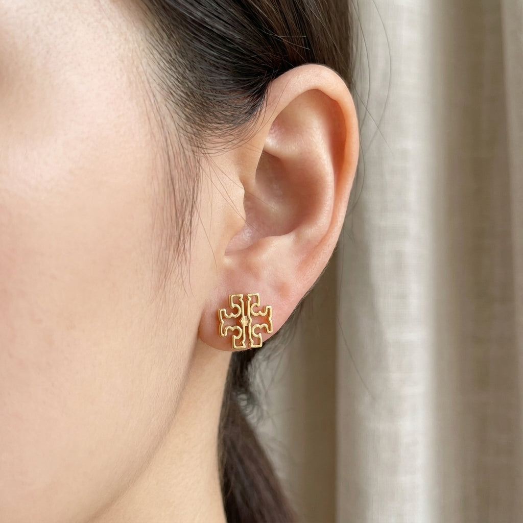Model wearing Tory Burch Britten Logo Earrings for a sophisticated, minimalist jewelry style