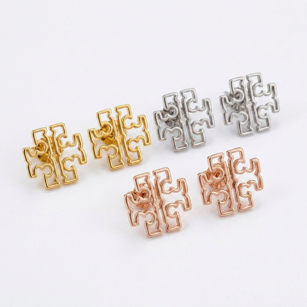 Angled shot of Tory Burch Britten Studs highlighting the 3D structure and polished edges