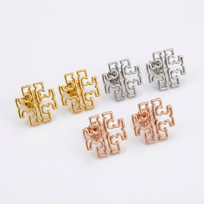 Angled shot of Tory Burch Britten Studs highlighting the 3D structure and polished edges
